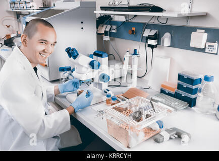 Smiling young scientist works in the lab Stock Photo