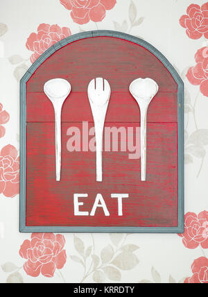 old red wooden background and white eat word on red rose wall Stock Photo