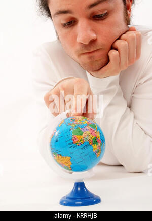 Junger Mann mit Miniatur-Globus - man with globe Stock Photo