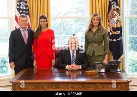 Argentinian President Mauricio Macri (left) and wife Juliana Awada pose with U.S. President Donald Trump and First Lady Melania Trump at the White House Oval Office April 27 2017 in Washington, DC.