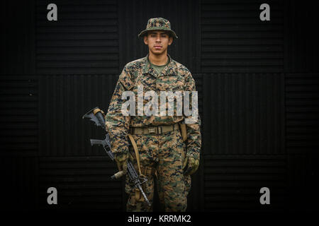 A U.S. Marine Corps soldier stand for a portrait with his rifle during the Marine Division Annual Squad Competition at Camp Hansen December 7, 2017 in Okinawa, Japan. Stock Photo