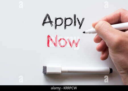 Apply now written on whiteboard Stock Photo