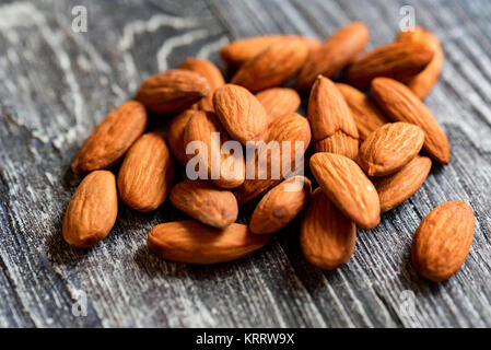Peeled almonds close-up on wooden table Stock Photo
