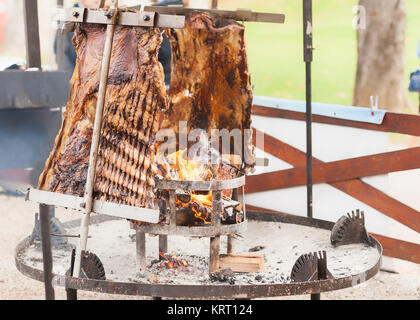 Traditional Argentinian asado roasted lamb grilled meat. Stock Photo