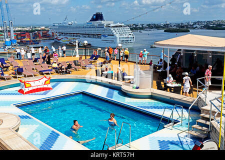 Rear pool deck of Holland America Line's Zuiderdam cruise ship with Norwegian Sun in background at port of Cartagena, Colombia. Stock Photo