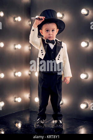 child magician with magic wand and hat Stock Photo