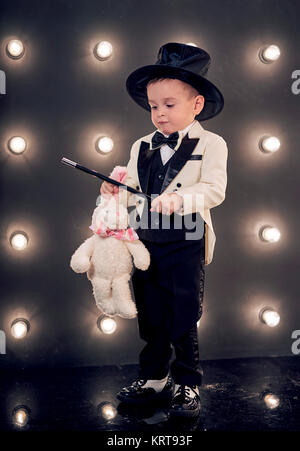 child magician with magic wand and hat Stock Photo
