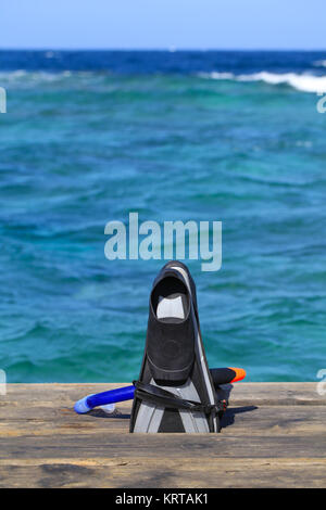 Flippers and snorkel on footbridge closely coral reef. Marsa Alam, Egypt. Stock Photo