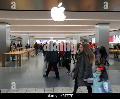 Hordes of shoppers in the Apple store the Queens Center Mall in the borough of Queens in New York on Sunday, December 17, 2017, a week before Christmas. Retailers are reporting a bump in sales for Christmas approaches as they lure shoppers in and increase foot traffic. (© Richard B. Levine) Stock Photo