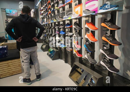 Customers browse footwear in the newly opened Asics flagship store on Fifth  Avenue in New York on Friday, December 15, 2017.(© Richard B. Levine Stock  Photo - Alamy