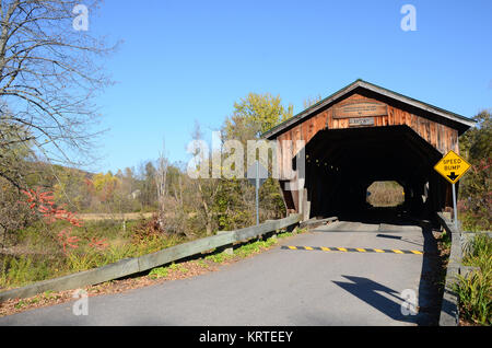 The Poland Covered Bridge, also known as the Junction Covered Bridge over the Lamoille River near Jeffersonville, Vermont, USA Stock Photo