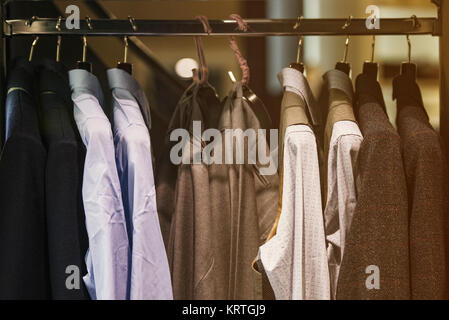 Men clothing on hangers in a fancy shoip Stock Photo