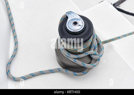 winch tie knot with green rope on a catamaran Stock Photo