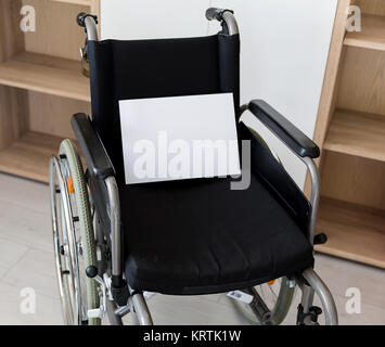 an empty wheelchair faces a wall unit