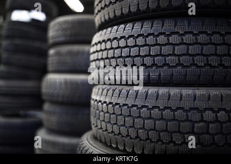 Tires for sale at a tire store - stacks of old used tires Stock Photo