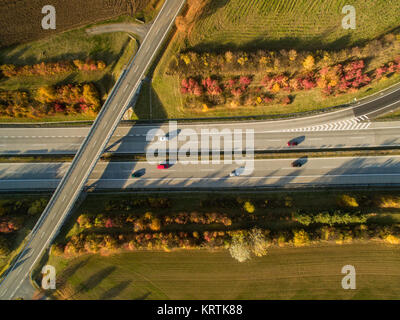 Aerial view of a highway amid fields with cars on it Stock Photo