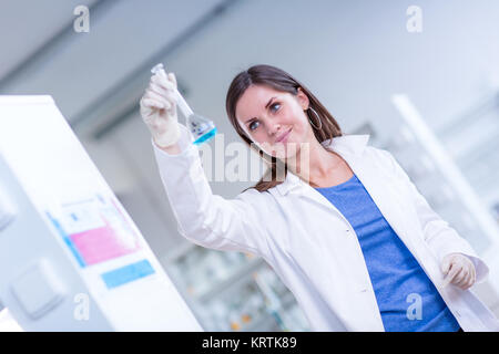 Portrait of a female chemistry student carrying out research in a chemistry lab (color toned image  shallow DOF) Stock Photo