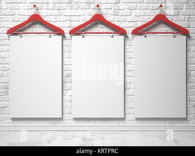 Cloth hangers and white canvas on the white painted brick wall Stock Photo