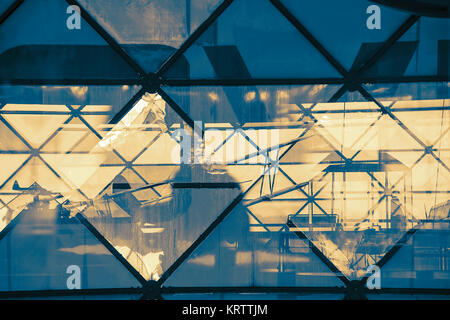 Abstract view through the triangular glass structure with reflection Stock Photo