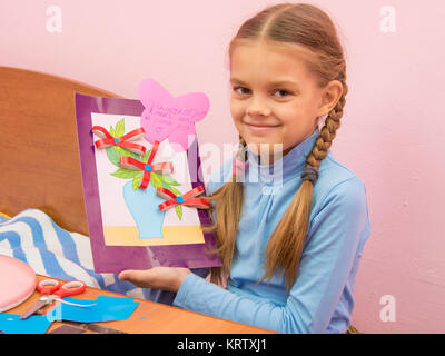 The girl made a birthday card for mom on Mothers Day Stock Photo