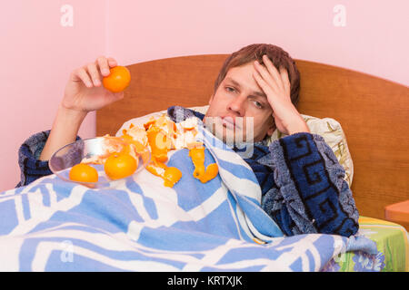 Sad man mandarins gorged itself looks in the frame Stock Photo