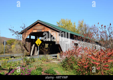 The Poland Covered Bridge, also known as the Junction Covered Bridge over the Lamoille River near Jeffersonville, Vermont, USA Stock Photo