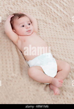 Cute baby on a brown blanket surprised Stock Photo
