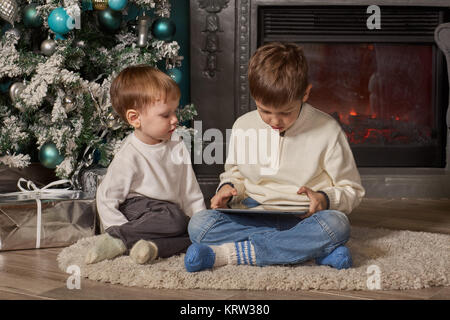 Small children with computer tablet. Stock Photo