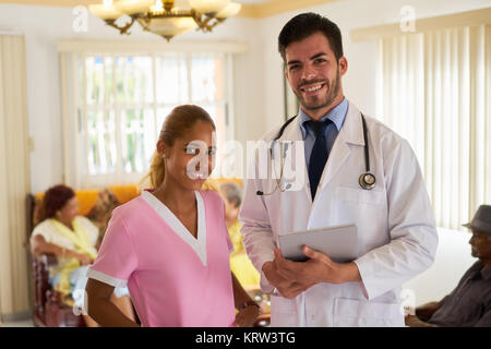 Meeting At Work With Doctor And Nurse In Hospice Stock Photo
