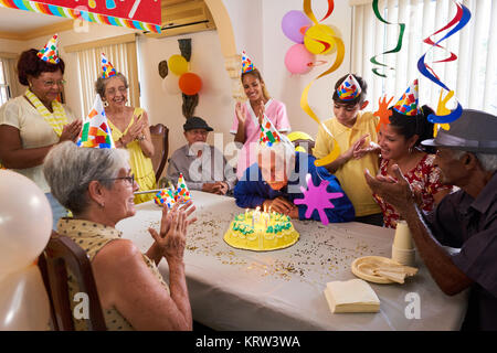 Family Reunion For Birthday Party Celebration In Retirement Home Stock Photo