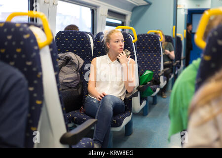 Woman travelling by train. Stock Photo