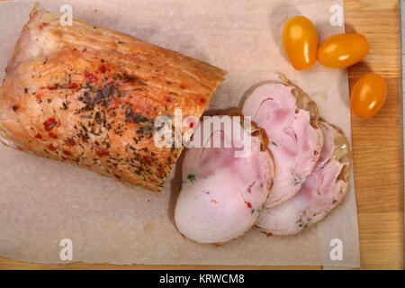 Homemade meatloaf from pork meat with spices on cutting board. Stock Photo