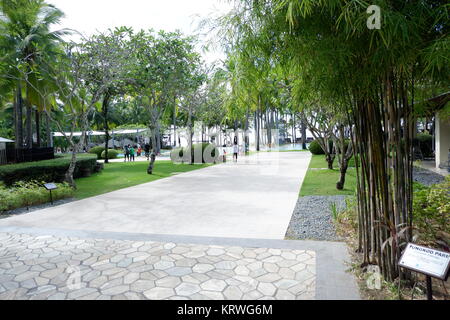 Beautiful views of pathway going on beach front and tourist enjoying the resort Stock Photo