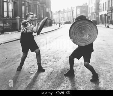 Children with shield and stick play knights, England, Great Britain Stock Photo