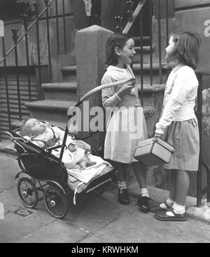 Two girls with baby and prams, England, Great Britain Stock Photo