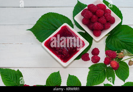 Raspberry jam and fresh raspberries ripe in the saucer Stock Photo