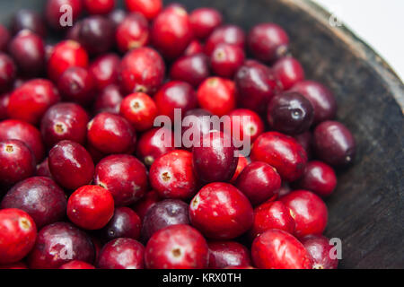 Fresh cranberries in rustic wooden bowl on burlap Background an Stock Photo