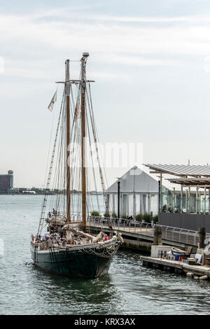 04.09.2017 Boston Massachusetts USA - Old big Sailboat sailing boat anchored leaving the harbor Stock Photo