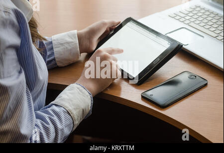 Woman in shirt sitting with a tablet Stock Photo