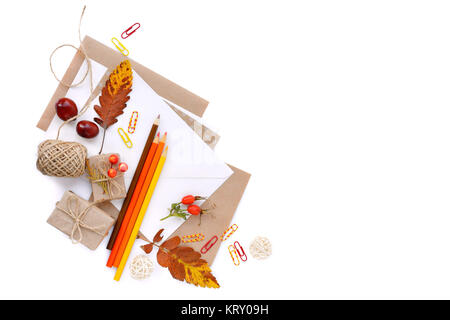 Background with autumn leaves, pencils and envelopes. Top view. Space for your text. Stock Photo