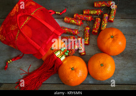 Oranges with Red Lucky Pouches and Firecracker Prepared for a Chinese New Year Stock Photo