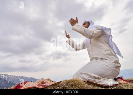 The iIslamic man praying   on the mountain. Stock Photo