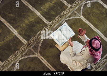 Religious muslim man praying inside the mosque Stock Photo