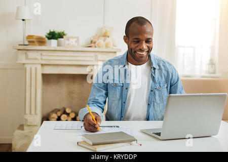 Joyful freelancer working from home Stock Photo