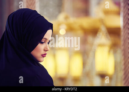 Young muslim woman praying in mosque Stock Photo