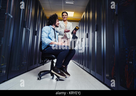 two young technicians working at a data center on server maintenance Stock Photo