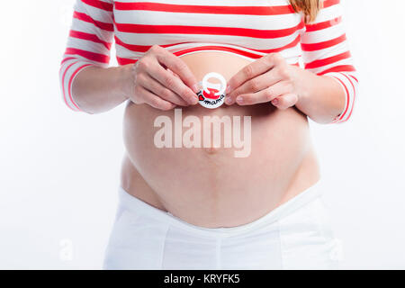Schwangere Frau mit Schnuller am Babybauch - pregnant woman with dummy Stock Photo