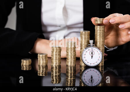 Saving Money Concept With Stopwatch Stock Photo