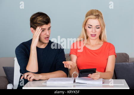 Worried Young Couple Calculating Their Bills Stock Photo