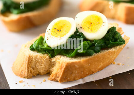 Crostini with Spinach and Quail Egg Stock Photo